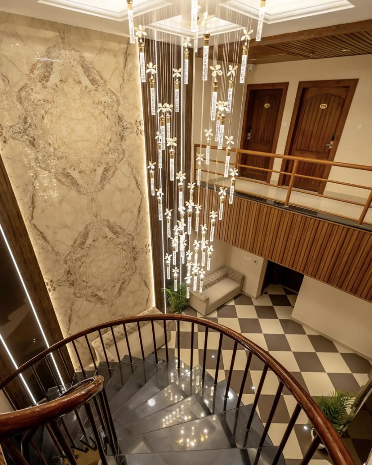 Grand staircase with crystal chandelier at The Arjuna Manor