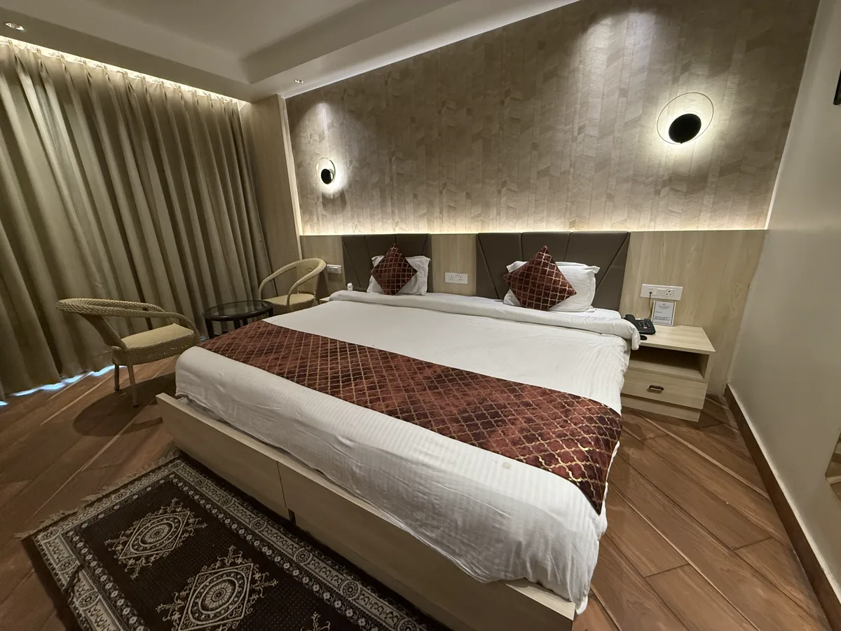 Spacious guest suite with textured wall panelling and heritage-inspired decor